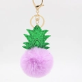 Close-up of purple faux fur pineapple keychain with green sequin leaves and gold metal ring - Taro Purple