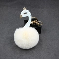 Detailed view of light blue glitter swan pendant with soft beige pompom and gold keychain - Off-white