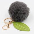 Close-up of faux rabbit fur pom pom with green leaf charm and gold lobster clasp - Dark Gray