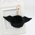 Detail view of black faux fur pompom keychain with wings and a gold lobster clasp - Faux Rabbit Fur / Black