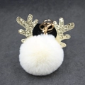 Detail of white faux fur pompom with golden glitter reindeer antlers on a metal keychain - 8cm Pompom / Off-white