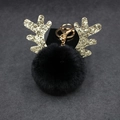 Close-up of black fluffy pom pom keychain with sparkling golden sequin reindeer antlers - 8cm Pompom / Black