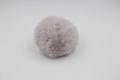 Detail of a dusty pink faux fur pompom with fluffy texture for bags and DIY crafts - 8cm Faux Rex Rabbit Ball / Light Gray