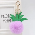 Detail of purple faux fur pineapple keychain with green leather leaves and gold clasp - 8cm / Taro Purple