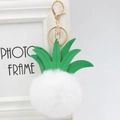 Detail of pineapple faux fur keychain with green PU leather leaves and golden lobster clasp - 8cm / White