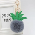 Macro detail of pineapple keychain with grey faux fur pompom and green PU leather leaves - 8cm / Dark Gray