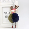 Detailed view of reindeer keychain with two-tone plush ball and festive red hat charm - Green And Navy