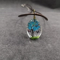 Collar ovalado de flores secas con árbol miniatura azul y mariposa en resina - Estilo árbol azul
