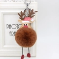 Plush Christmas reindeer keychain with brown pom pom and red boots on a white frame - Brown