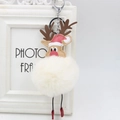 Detail of reindeer plush ball keychain with red Santa hat and metal clasp - Off White