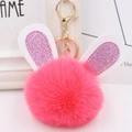 Detail of pink faux fur pom pom keychain with glitter bunny ears and golden metal clasp - Gold Key Chain Style / Watermelon red