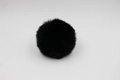 Close-up of soft black faux fur pom pom with dense synthetic fibers for bag accessories - 8cm Faux Rex Rabbit Ball / Black