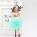 Close-up of reindeer plush pom pom keychain with green fur and red festive hat - Mint Green