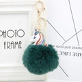 Detailed view of the dark green plush pompom and unicorn charm with gold keychain - Dark Green