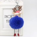 Close-up of a blue reindeer pompom keychain with a red Santa hat and metal ring - Sapphire Blue