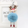 Close-up of reindeer plush pom-pom keychain with blue fur and festive antlers - Teal