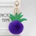 Detailed close-up of purple faux fur pineapple keychain with green PU leather leaves - 8cm / Purple