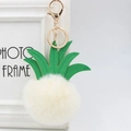 Detail of pineapple faux fur pompom keychain with green leather leaves and gold clasp - 8cm / Off-white