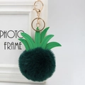 Detailed view of fluffy pineapple keychain with green leather leaves and gold clasp - 8cm / Dark Green