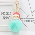 Detailed view of mint green pom-pom Santa keychain with a gold lobster clasp - Mint Green