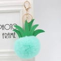 Close-up of mint green fur pompom pineapple keychain with gold lobster clasp - 8cm / Mint Green