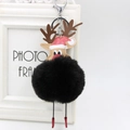 Detail of reindeer faux fur pompom keychain with red Christmas hat and silver metal clasp - Black