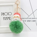 Detail of a fluffy green pom pom Santa keychain with a gold clasp for Christmas - Army Green
