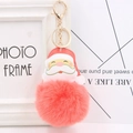 Detailed view of red faux fur Santa Claus keychain with high-quality gold metal hardware - Orange Red