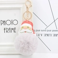 Close-up of Santa Claus pompom keychain with grey faux fur and golden hardware link - Light Gray