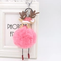 Pink plush reindeer keychain with metal clasp and Christmas hat hanging on a frame - Watermelon red