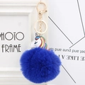 Close-up of fluffy blue pompom keychain with white unicorn head and golden clasp - Sapphire Blue
