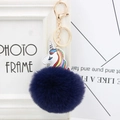Close-up of fluffy dark blue pompom and rainbow PU leather unicorn keychain with gold clasp - Navy Blue