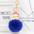 Close-up of Santa Claus leather charm with soft royal blue pompom and golden keyring - Sapphire Blue