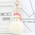 Close-up of Santa Claus PU leather pendant with fluffy white pom pom and golden lobster clasp - Off-white