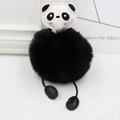Close-up of adorable panda plush keychain featuring a fluffy faux fur ball and leather head - Black