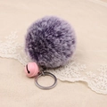 Detail of purple faux rabbit fur pompom keychain with a pink bell and silver ring - 8cm Faux Rabbit Fur With Bell / Two-tone Purple