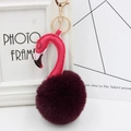 Macro detail of plush flamingo keychain with purple faux fur ball and gold metal clasp - Purple Red and Rose