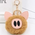 Detail of a brown plush pig keychain with pink leather ears and golden lobster clasp - Gold Key Chain Style / Coffee