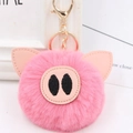 Close-up of pink fluffy pig keychain with soft faux leather ears and gold metal clasp - Gold Key Chain Style / Deep Pink