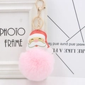 Detail of Santa Claus keychain featuring a large pink faux fur pompom and gold lobster clasp - Light Pink