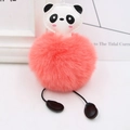 Detail showing fluffy coral orange fur pom-pom body and cute panda face on this bag charm - Orange Red