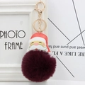 Detail of Santa Claus keychain with deep red faux fur pompom and golden metal clasp - Purplish Red