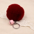 Detail of burgundy faux fur pompom keychain with pink bell on beige lace background - 8cm Faux Rabbit Fur With Bell / Burgundy