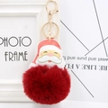 Close-up of Santa Claus PU leather pendant with a fluffy red fur pompom and gold keychain - Burgundy