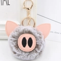 Close-up of cute plush pig keychain with soft grey fur, pink ears and golden lobster clasp - Gold Key Chain Style / Two-tone Grey