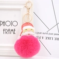 Detailed view of the fluffy magenta faux fur pom pom and festive Santa Claus keychain charm - Rose Red
