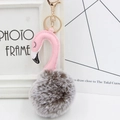 Detail of pink flamingo plush keychain with fluffy faux fur ball and gold metal clip - Two-Tone Gray and Pink