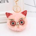 Close-up of pink faux fur owl keychain featuring red sequins and golden lobster clasp - Gold Key Chain Style / Korean Pink Red