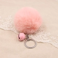 Close-up of soft pink faux fur pompom keychain with matching bell on woven background - 8cm Faux Rabbit Fur With Bell / Pink