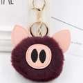 Detail of cute purple plush pig keychain with soft faux fur and golden metal lobster clasp - Gold Key Chain Style / Fuschia
